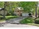 Charming two-story home with a manicured lawn and mature trees at 7045 Threadstone Overlook, Johns Creek, GA 30097