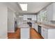 Spacious kitchen with white cabinets, granite countertops, stainless appliances, and island at 7045 Threadstone Overlook, Johns Creek, GA 30097