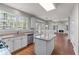 Open concept kitchen with granite countertops, stainless steel appliances, and lots of light at 7045 Threadstone Overlook, Johns Creek, GA 30097