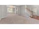 Spacious living room with carpet flooring, chandelier, and neutral paint at 7045 Threadstone Overlook, Johns Creek, GA 30097