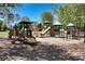 A colorful playground with multiple slides, climbing structures, and a soft landing surface at 7045 Threadstone Overlook, Johns Creek, GA 30097