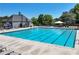 A sparkling community pool with lounge chairs and tables, perfect for relaxation and fun at 7045 Threadstone Overlook, Johns Creek, GA 30097