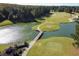 Stunning aerial view of the community golf course, lake, and bridge on a sunny day at 81 Richmond Way, Villa Rica, GA 30180
