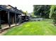 Lush backyard with a deck, patio, and manicured lawn at 81 Richmond Way, Villa Rica, GA 30180