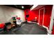 Red basement with workout area and concrete wall at 81 Richmond Way, Villa Rica, GA 30180