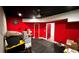 Red basement with workout area and concrete wall at 81 Richmond Way, Villa Rica, GA 30180