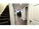 Finished basement with stairs, vinyl floors, and a kitchenette with a black table and microwave at 81 Richmond Way, Villa Rica, GA 30180