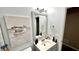 Charming bathroom featuring a framed mirror, vanity with sink, and soothing artwork at 81 Richmond Way, Villa Rica, GA 30180