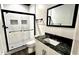 Bathroom showcasing a black framed glass shower with niches and black countertop at 81 Richmond Way, Villa Rica, GA 30180