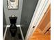 Stylish black toilet in gray bathroom featuring modern finishes, and adjacent doorway at 81 Richmond Way, Villa Rica, GA 30180