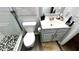 Bathroom with a sink, toilet, and a black and white tiled shower with glass door at 81 Richmond Way, Villa Rica, GA 30180