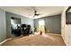 Bedroom with a ceiling fan, gray walls, work desk, and large window allowing natural light at 81 Richmond Way, Villa Rica, GA 30180