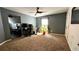 Bedroom with neutral colored walls, work desk, large window, and ceiling fan at 81 Richmond Way, Villa Rica, GA 30180