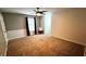 Spacious bedroom featuring soft carpeting, a ceiling fan, natural light, and neutral colors at 81 Richmond Way, Villa Rica, GA 30180