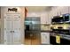 Open kitchen featuring stainless steel appliances, pantry, and mosaic tile backsplash at 81 Richmond Way, Villa Rica, GA 30180