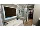 Modern main bathroom featuring a tub, walk-in shower with decorative tile, and spacious walk-in closet at 81 Richmond Way, Villa Rica, GA 30180