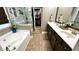 Luxurious main bathroom with double vanity, soaking tub, and walk-in shower at 81 Richmond Way, Villa Rica, GA 30180