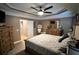 Main bedroom featuring a decorative trey ceiling, comfortable king size bed, and wood furnishings at 81 Richmond Way, Villa Rica, GA 30180