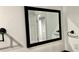 Bathroom mirror with a black frame, reflecting a view into another room at 81 Richmond Way, Villa Rica, GA 30180