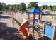A community playground featuring a climbing structure, slides, and swings, perfect for Gathering fun at 81 Richmond Way, Villa Rica, GA 30180
