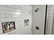 This shower stall has white subway tile with two built in storage spaces and a glass partition at 81 Richmond Way, Villa Rica, GA 30180