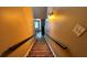 Carpeted stairway leading to the home's entrance, featuring a modern light fixture at 81 Richmond Way, Villa Rica, GA 30180