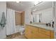 Bathroom boasts a shower-tub combination, tile floors, a vanity with granite counters, and bright lighting at 860 Peachtree Ne St # 1511, Atlanta, GA 30308