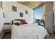 Sun-filled bedroom features a large window with city views, modern decor, and a comfortable bed with a green headboard at 860 Peachtree Ne St # 1511, Atlanta, GA 30308