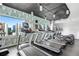 Modern gym with treadmills, ellipticals, and skyline views through large windows at 860 Peachtree Ne St # 1511, Atlanta, GA 30308