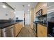 Well-lit kitchen featuring stainless steel appliances, wood cabinets, and dark countertops at 860 Peachtree Ne St # 1511, Atlanta, GA 30308