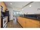 Modern kitchen with stainless steel appliances, dark countertops, and wood cabinetry at 860 Peachtree Ne St # 1511, Atlanta, GA 30308