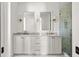Bathroom featuring double sinks, white cabinets, marble countertops, and a glass door shower at 98 Sheridan Dr, Atlanta, GA 30305