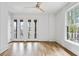 Bright bedroom featuring a ceiling fan, hardwood floors, and large windows offering an abundance of natural light at 98 Sheridan Dr, Atlanta, GA 30305