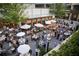 Large outdoor dining space with umbrellas and festive lighting, perfect for social gatherings and dining experiences at 98 Sheridan Dr, Atlanta, GA 30305