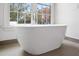 Relaxing bathroom with a modern soaking tub near a bright window at 98 Sheridan Dr, Atlanta, GA 30305