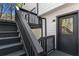 Rear access to the home via stairs and a door featuring a black trim package at 5017 Tanaga Ct, Stone Mountain, GA 30087