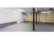 Unfinished basement area ready for customization and features high ceilings and a garage door at 5017 Tanaga Ct, Stone Mountain, GA 30087