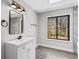Bright and modern bathroom featuring new vanity with stainless steel fixtures and beautiful tile flooring at 5017 Tanaga Ct, Stone Mountain, GA 30087