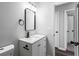 Modern bathroom featuring new vanity with stainless steel fixtures, modern mirror and light fixtures at 5017 Tanaga Ct, Stone Mountain, GA 30087