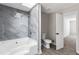 Spacious bathroom featuring a skylight, separate tub, and shower and new tile flooring at 5017 Tanaga Ct, Stone Mountain, GA 30087