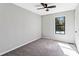 Cozy bedroom with a ceiling fan, carpet floors and a large window at 5017 Tanaga Ct, Stone Mountain, GA 30087
