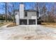 Spacious driveway leading to a two-car garage, accented by mature trees and meticulously kept landscaping at 5017 Tanaga Ct, Stone Mountain, GA 30087