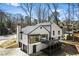 Stunning exterior featuring a sunroom, deck, and garage, with a large driveway and well-maintained surroundings at 5017 Tanaga Ct, Stone Mountain, GA 30087