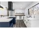Modern kitchen with white cabinets, quartz countertops, and a stylish kitchen island at 5017 Tanaga Ct, Stone Mountain, GA 30087
