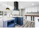 Bright kitchen with a large island, sleek range hood, and view of the stairway at 5017 Tanaga Ct, Stone Mountain, GA 30087