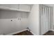Bright laundry room featuring a built in overhead cabinets, and wood patterned flooring at 5017 Tanaga Ct, Stone Mountain, GA 30087