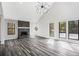 Living room with stone fireplace, wood-look flooring, and large windows at 5017 Tanaga Ct, Stone Mountain, GA 30087