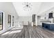 Spacious living room with a vaulted ceiling, large windows and staircase at 5017 Tanaga Ct, Stone Mountain, GA 30087