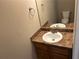 Compact half-bathroom featuring a vanity with a laminate countertop and a round, white sink at 5942 King Way Walk, Lithonia, GA 30058