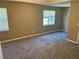 Spacious bedroom with plush carpet, fresh paint, and two windows at 5942 King Way Walk, Lithonia, GA 30058